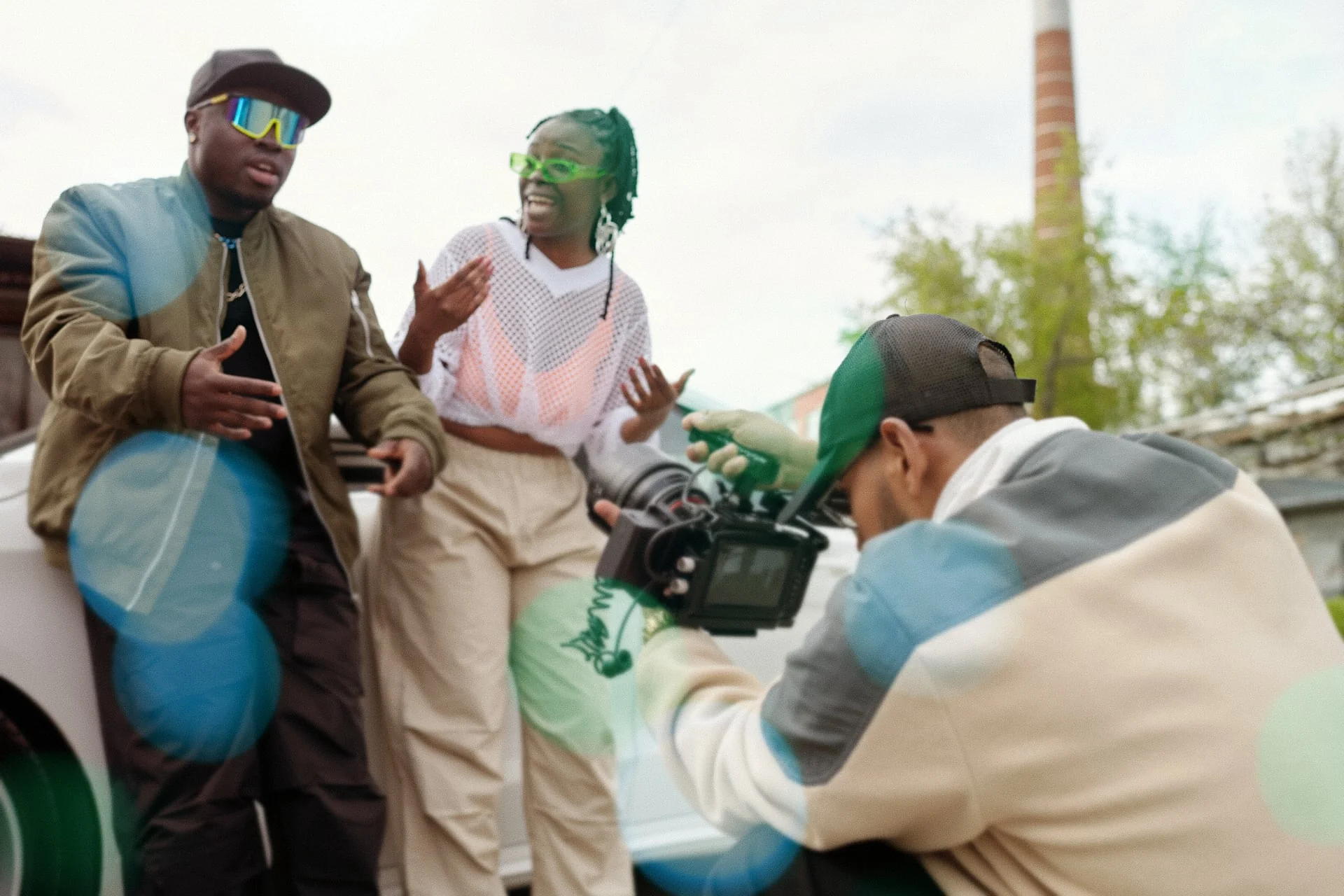 Two hip hop artists being filmed for a music video by a camera operator on location — a Castella Media Group hip hop music video promotion scene